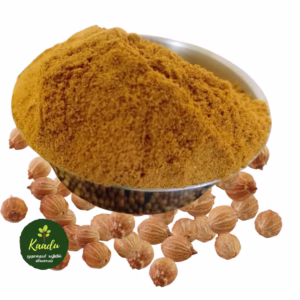 Coriander powder in a bowl with whole coriander seeds scattered around, showcasing the natural texture and freshness